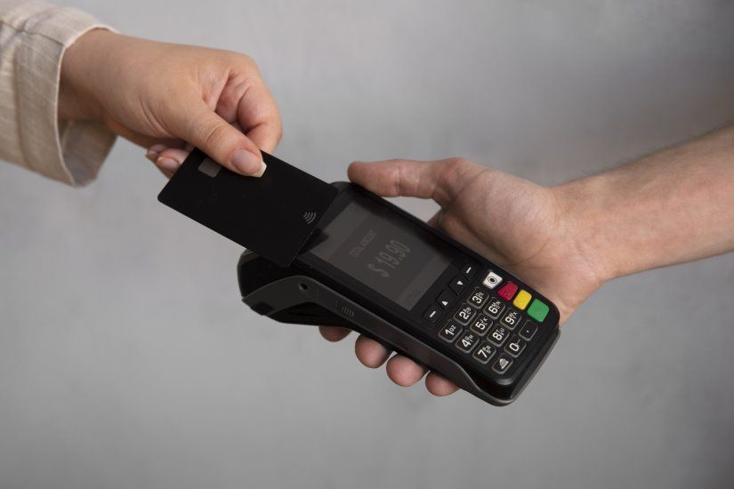 high-angle-customer-paying-with-nfc-device_23-2150690008.jpg